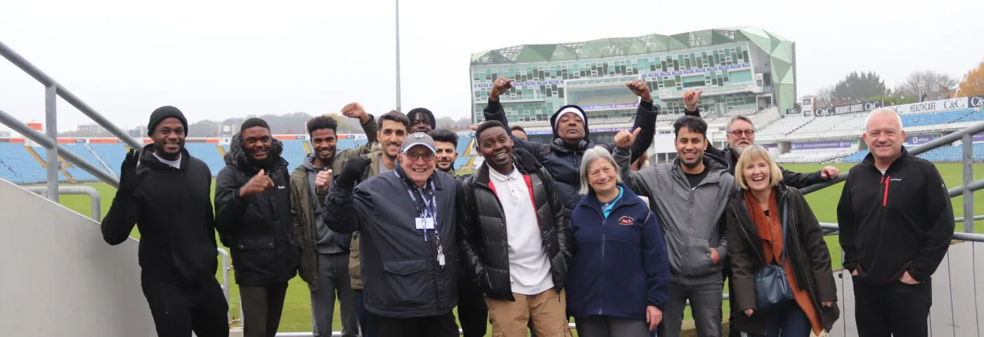 Refugees take part in a stadium tour run by the YCF. Strong poses present when celebrating towards the camera