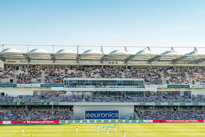 An image of the Howard stand full of spectators and cricket taking place on the field during the 2019 Ashes at Headingley.