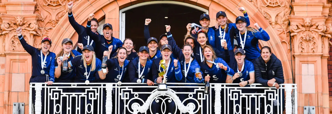 Northern Diamonds celebrating winning the Rachael Heyhoe Flint Trophy on the balcony of their changing room at Lord's in 2022.