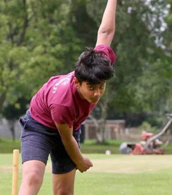 Young male bowler practicing with a pink ball before a game