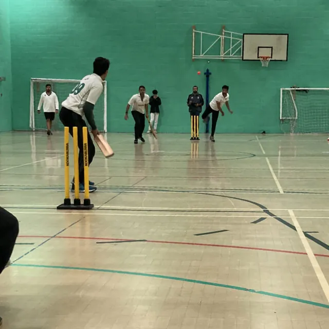 bowling during the indoor cricket league competition