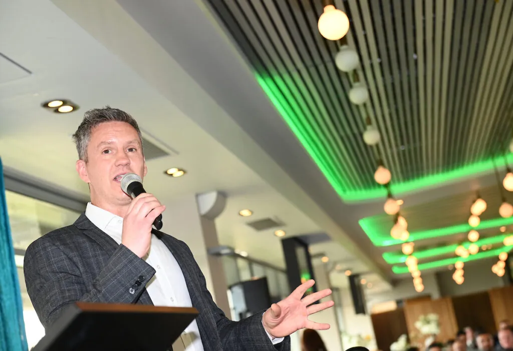 Stephen Vaughan, is pictured welcoming guests at the Eid Milan celebration. 