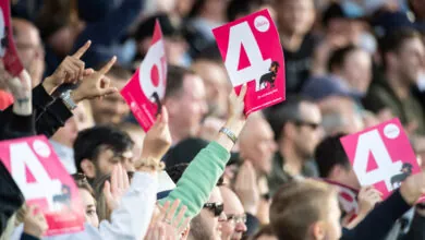 Crowds holding up their cards signaling four at Headingley