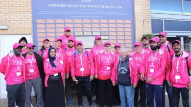 The Yorkies Welcome team in front of the Century Club Board
